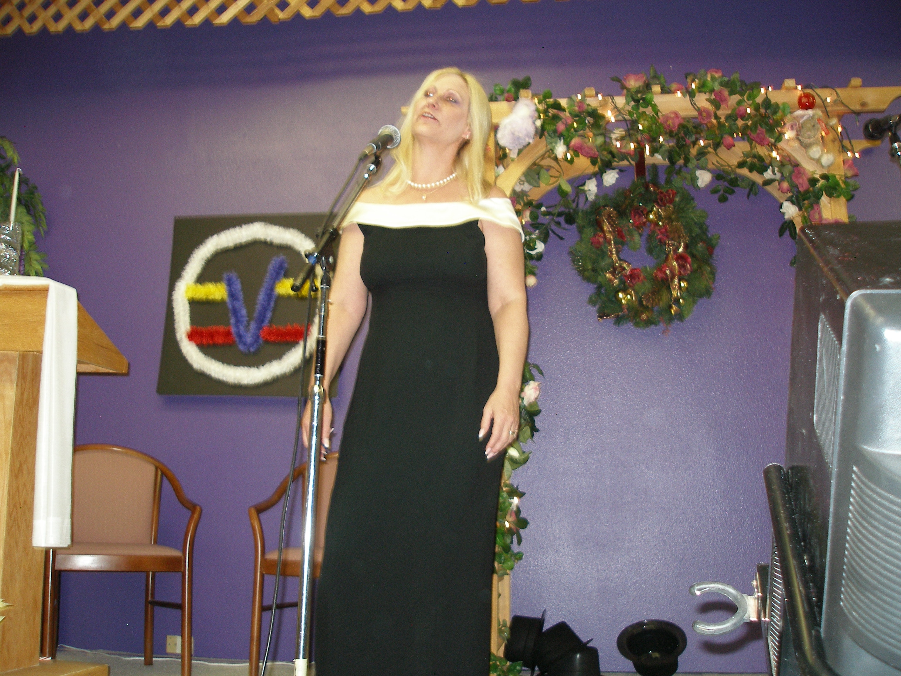 Woman singing at microphone at Christmas Eve 2008 service