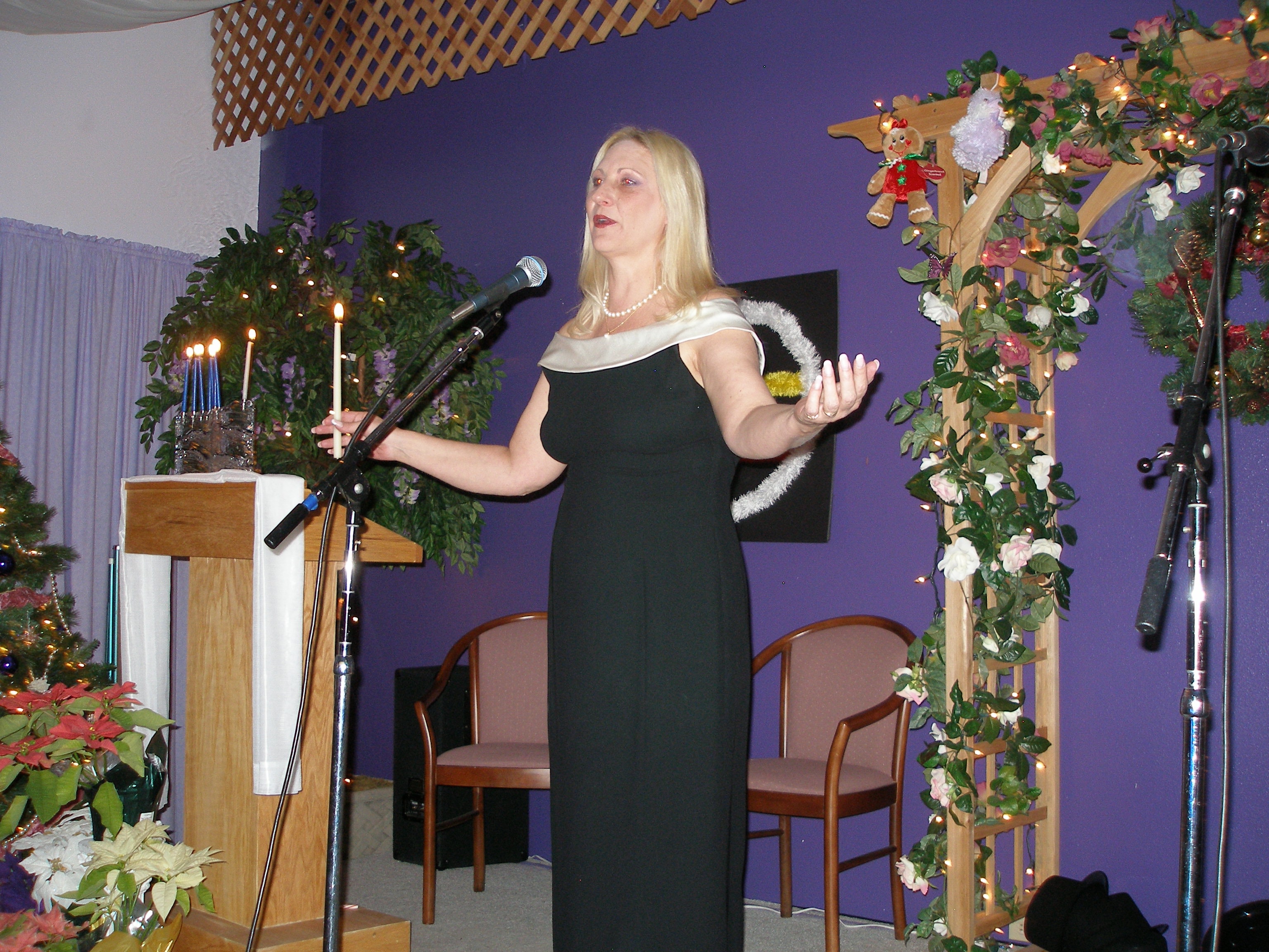 Woman speaking at microphone at Christmas Eve 2008