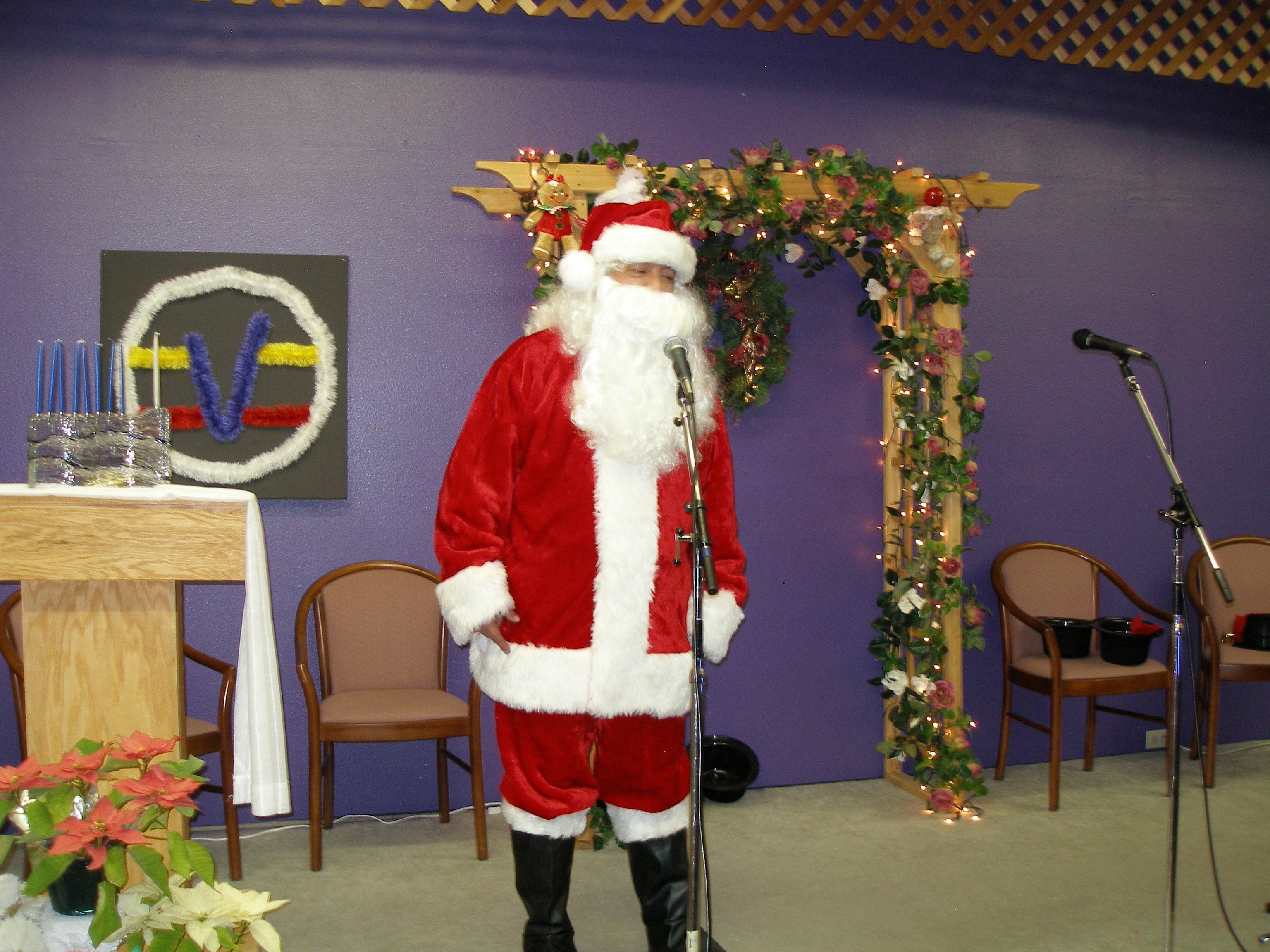 Santa Claus at microphone at Christmas Eve 2008 service