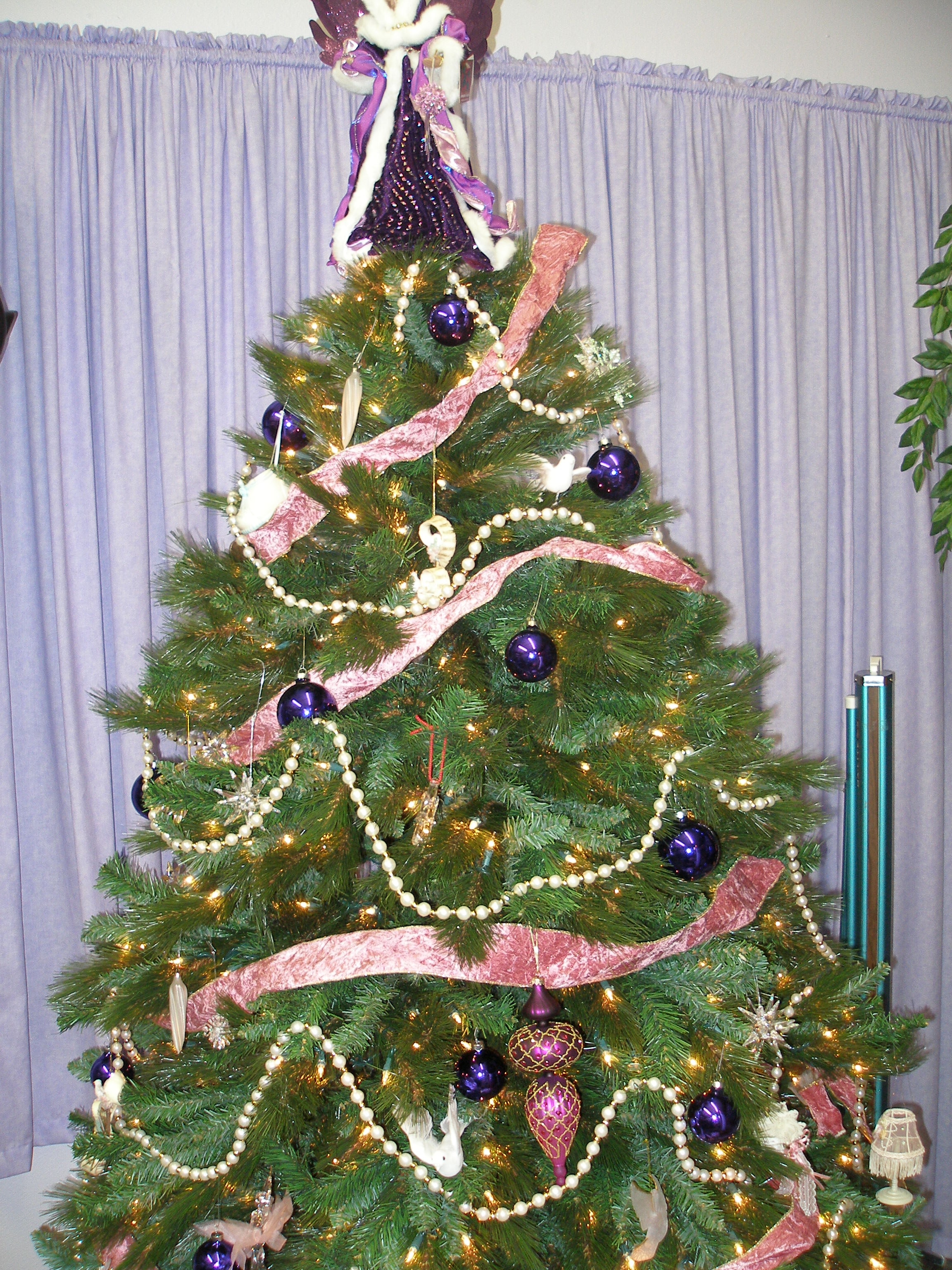 Decorated Christmas tree with purple ornaments and pink ribbon at Oasis CSL 2008