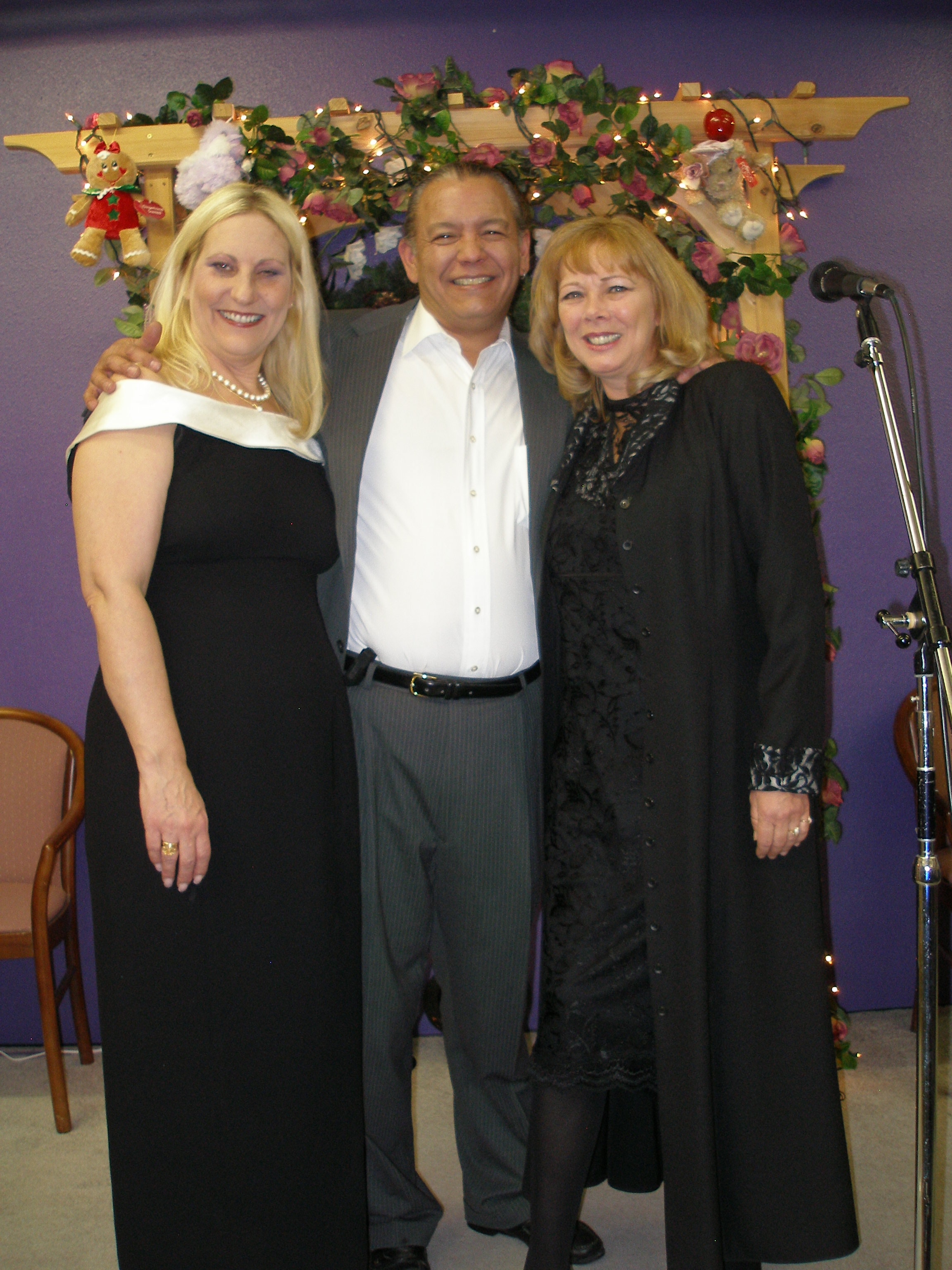 Three people posing together at Christmas Eve 2008 celebration