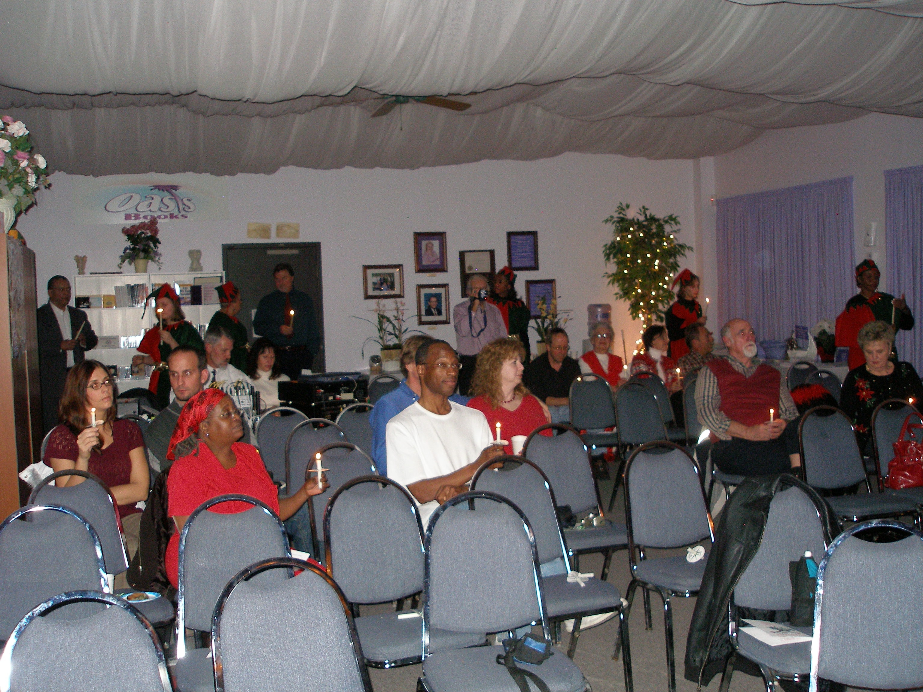 Woman lighting menorah candles at Christmas Eve 2008 service