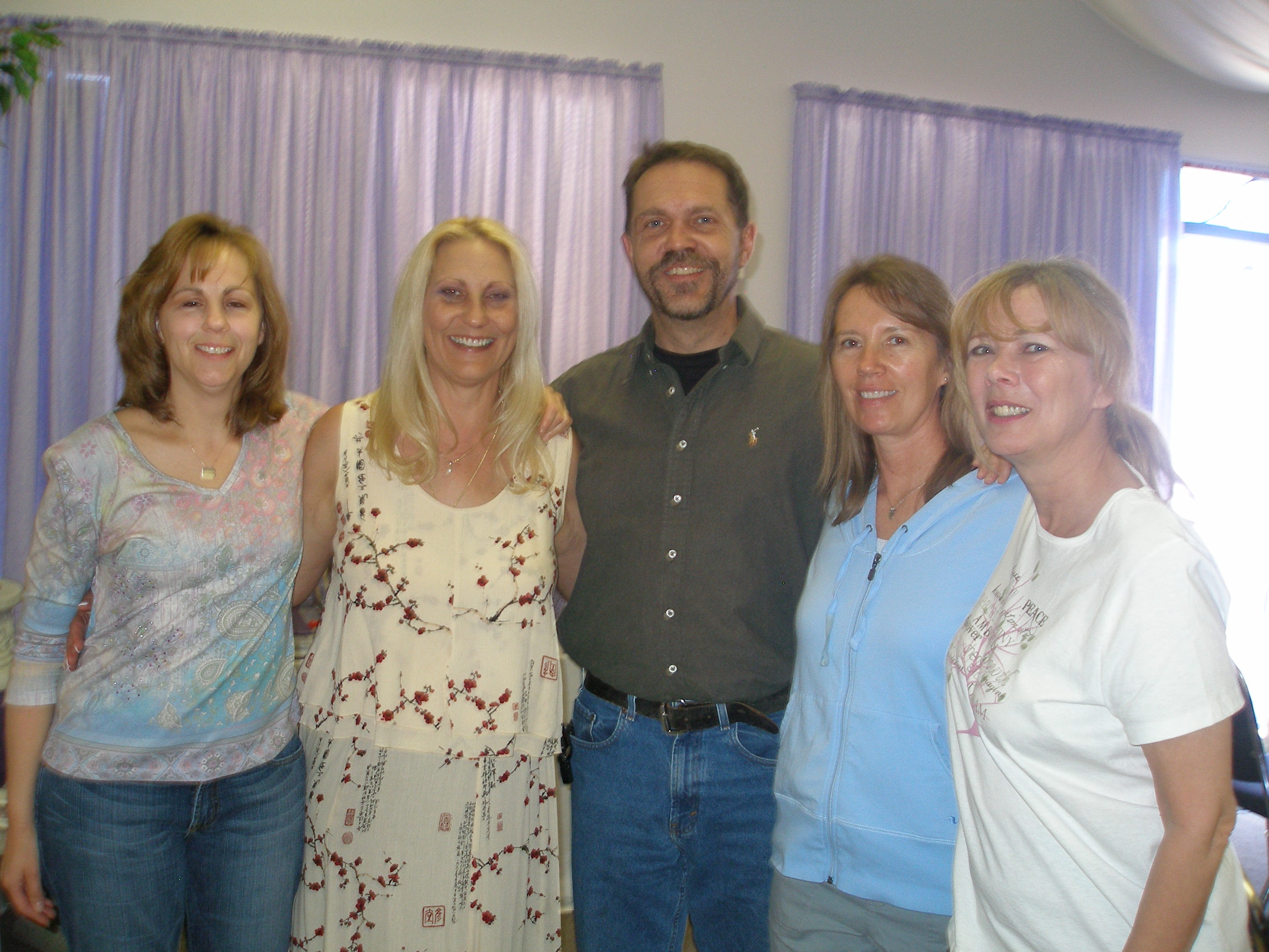 Five community members smiling together at Oasis CSL