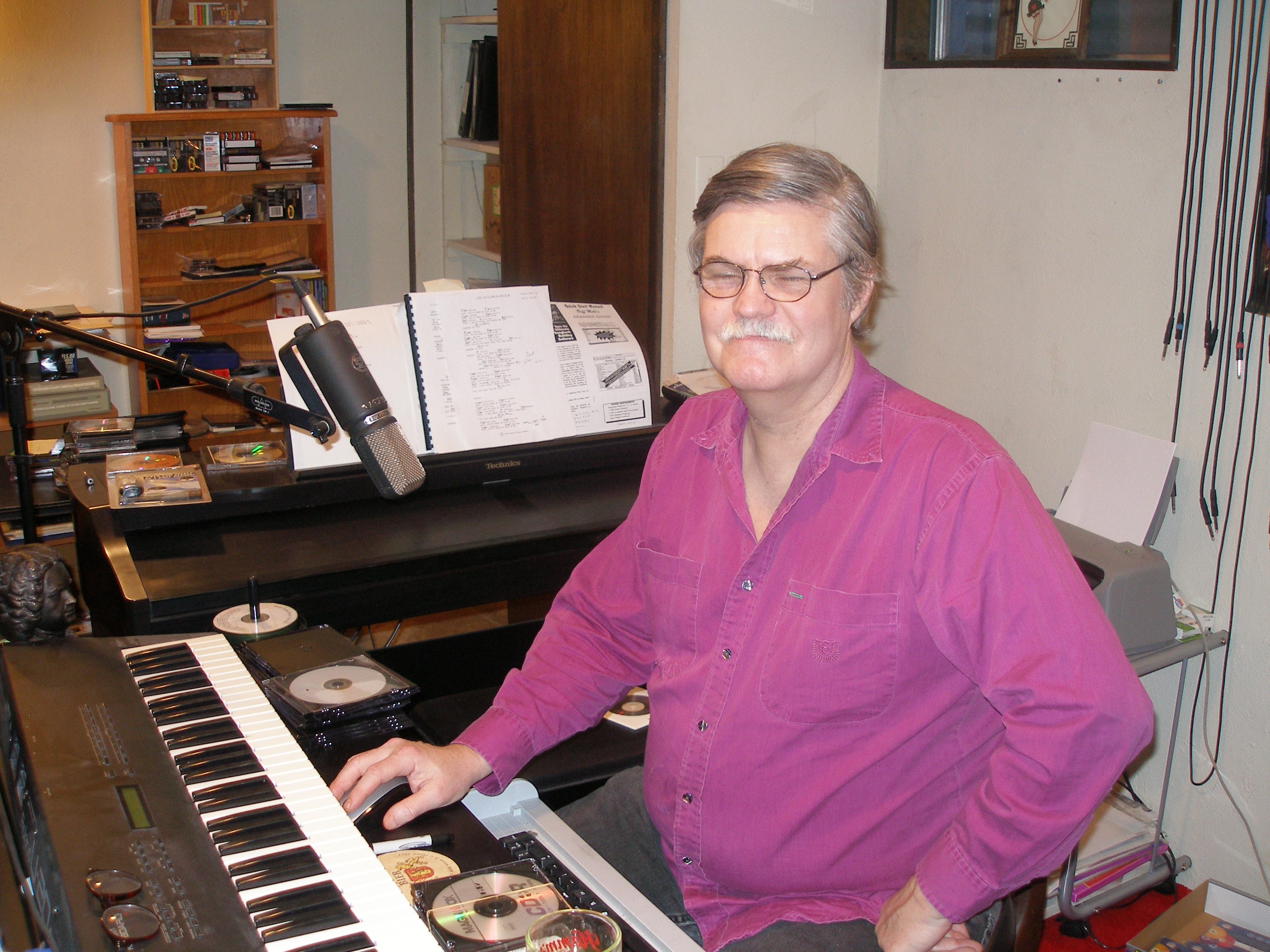Musician at keyboard in recording studio at Oasis CSL