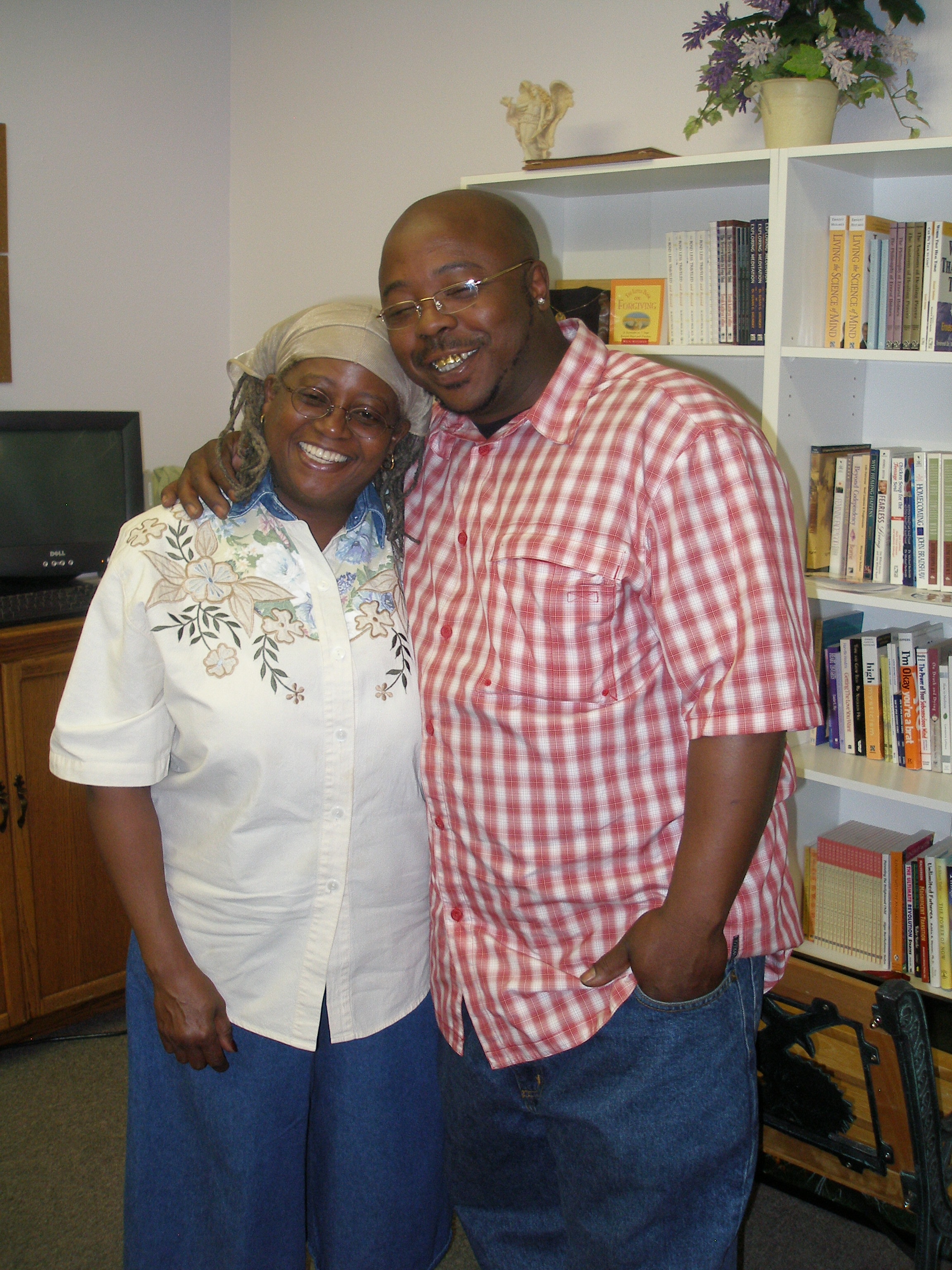 Two community members smiling together in the Oasis CSL bookstore