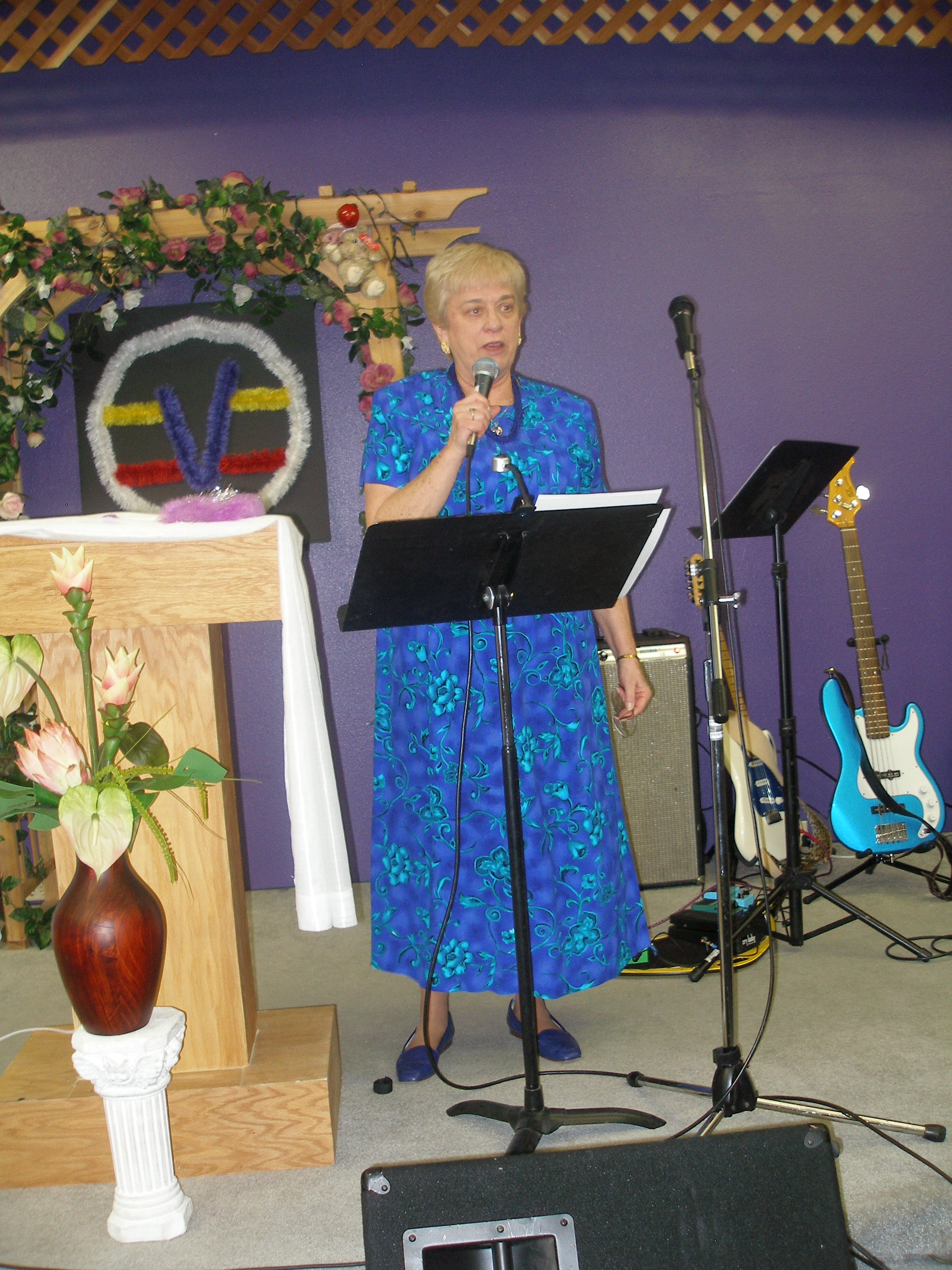 Woman speaking at microphone at Rev. S. Tucker's ordination