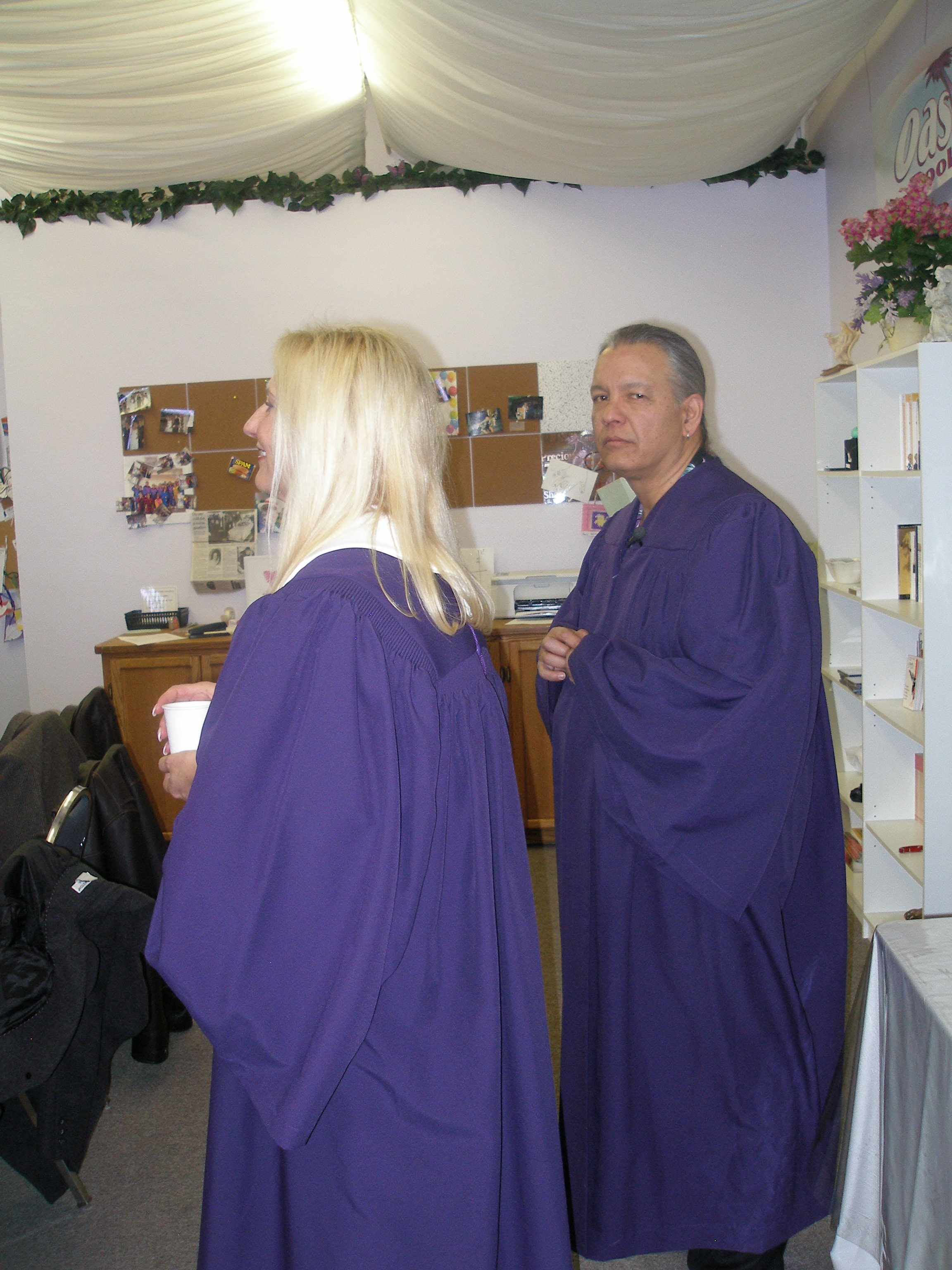 Two people in purple robes at Rev. S. Tucker's ordination