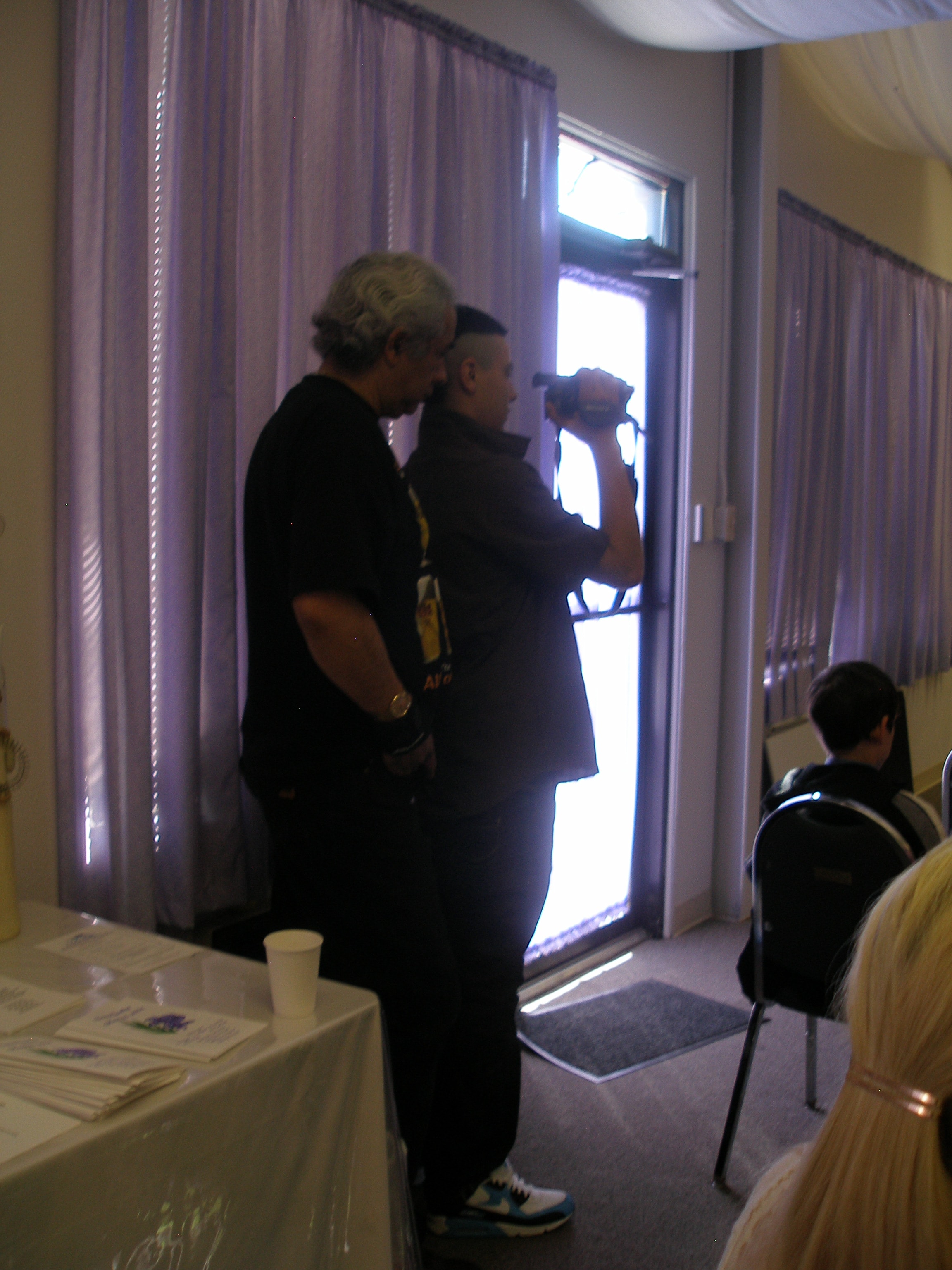 Two men filming the ordination ceremony