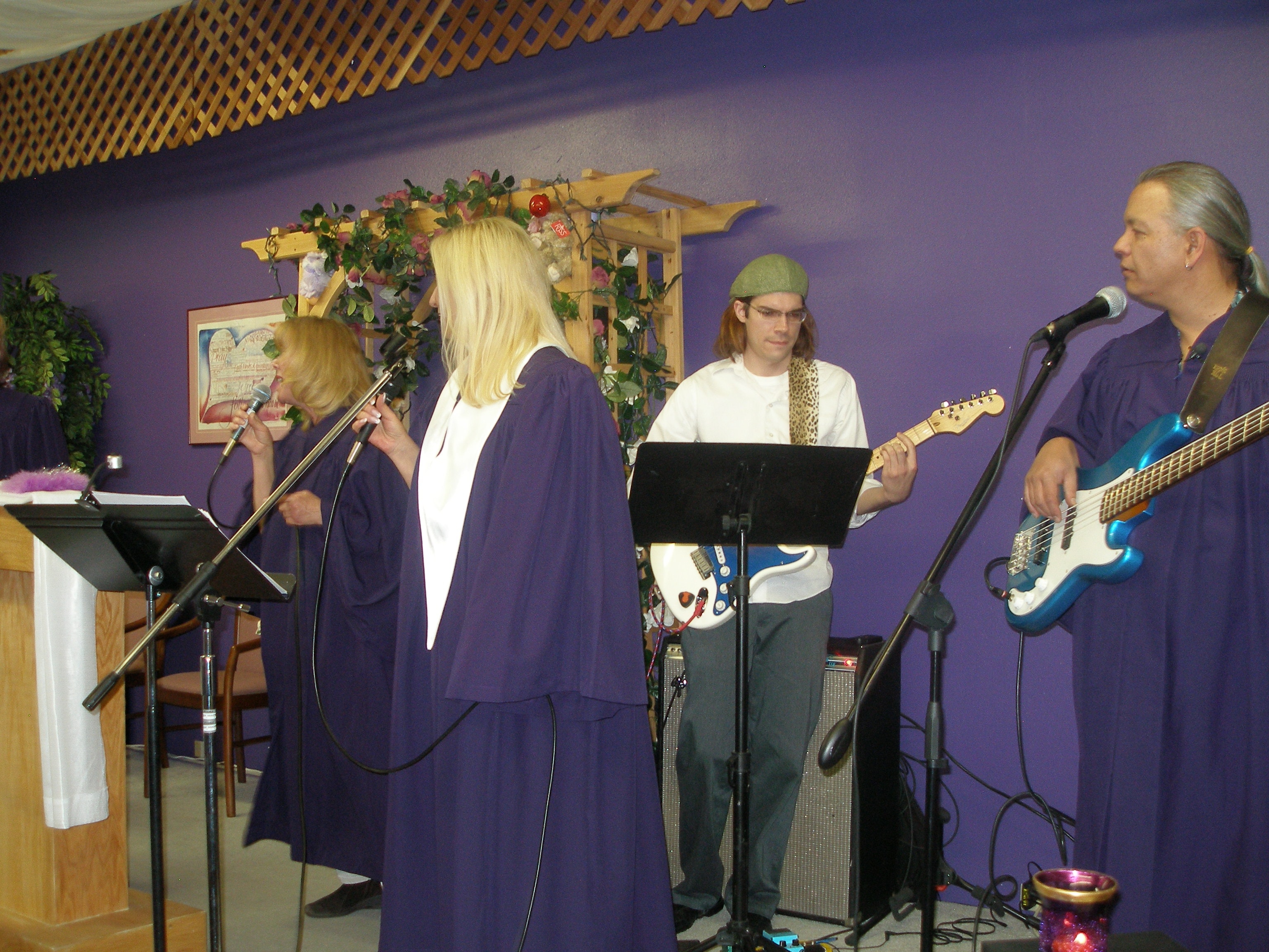 Band and choir performing at Rev. S. Tucker's ordination — singers and guitarists in purple robes