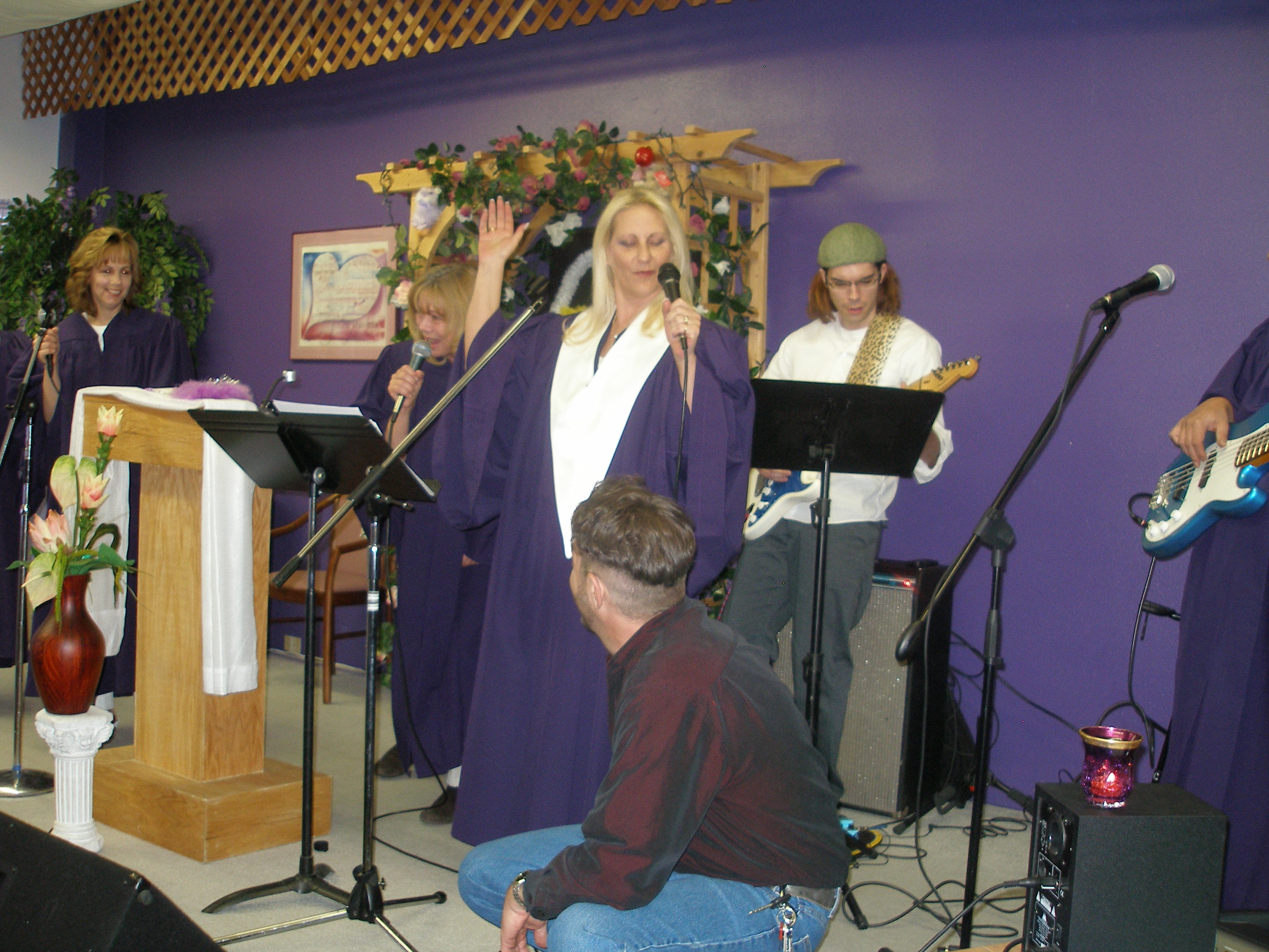 Full ensemble on stage with Rev. S. Tucker at center during ordination ceremony